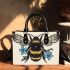 Bee with a blue flower on its back small handbag