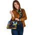 Cute black and tan dachshund in the garden with colorful tulips shoulder handbag