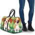 Cute brown and white puppy is sitting on the grass 3d travel bag