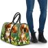Cute brown and white puppy sits on the grass 3d travel bag