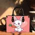 Cute cartoon rabbit playing with a carrot small handbag