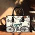 skeleton king riding bike with trumpet and music notes Small handbag