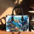 Turtle swimming among coral reefs small handbag