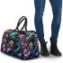 Vibrant teal frog with large eyes sits on top of colorful flowers 3d travel bag