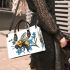 Bumblebee holding a blue forgetmenot flower small handbag