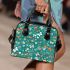 Butterflies and flowers scattered across shoulder handbag