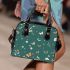 Butterflies and flowers scattered across shoulder handbag