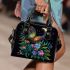 Colorful glowing butterfly surrounded by flowers and leaves shoulder handbag