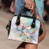 Cute butterfly surrounded by pastel flowers shoulder handbag