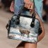 Cute little deer standing in the snow shoulder handbag