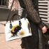 Cute smiling bee sitting on a daisy flower small handbag