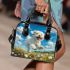 Cute white puppy running in a flower field shoulder handbag