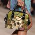 Green frog playing the banjo on top of human skull shoulder handbag