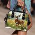 Whitetailed buck standing in a meadow with daisies shoulder handbag