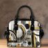 Abstract composition of circles and lines in gold shoulder handbag