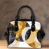 Abstract composition of circles and lines in gold shoulder handbag