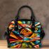 Abstract painting of fish vibrant colors geometric shoulder handbag