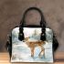 Adorable fawn standing in the snow shoulder handbag