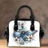 Blue butterfly with white flowers around shoulder handbag