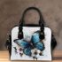 Blue butterfly with white flowers around shoulder handbag