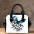 Blue butterfly with white flowers around shoulder handbag