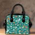 Butterflies and flowers scattered across shoulder handbag