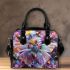 Colored butterfly surrounded by vibrant flowers shoulder handbag