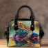 Colorful frog with an eye on its back shoulder handbag