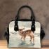 Cute baby deer standing in the snow shoulder handbag