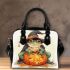 Cute cartoon frog wearing a witch hat sitting on pumpkin shoulder handbag