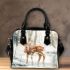 Cute deer standing in the snow shoulder handbag