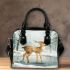 Cute deer standing in the snow shoulder handbag