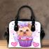 Cute yorkshire terrier dog in a cupcake shoulder handbag