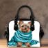 Cute yorkshire terrier wrapped in teal blanket shoulder handbag