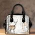 Deer with antlers stands in the forest shoulder handbag