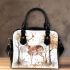 Deer with antlers stands in the forest shoulder handbag