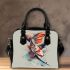 Koi fish with butterfly wings is depicted shoulder handbag