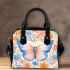 Orange butterfly surrounded by colorful spring flowers shoulder handbag