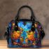 Two colorful owls sitting on the edge of an ornate mirror shoulder handbag