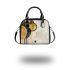 Abstract composition of circles and lines in gold shoulder handbag