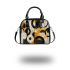 Abstract composition of circles and lines in gold shoulder handbag