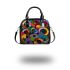 Abstract composition of circular shapes and lines shoulder handbag