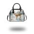 Adorable fawn standing in the snow shoulder handbag