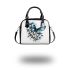 Blue butterfly with white flowers around shoulder handbag