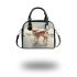 Cute baby deer standing in the snow shoulder handbag