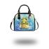 Cute frog wearing a crown sitting on golden ball shoulder handbag