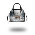Cute little deer standing in the snow shoulder handbag
