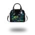 Glowing green frog sits on the ground surrounded shoulder handbag