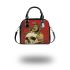 Green frog playing the banjo on top of human skull shoulder handbag