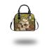 Green frog playing the banjo on top of human skull shoulder handbag